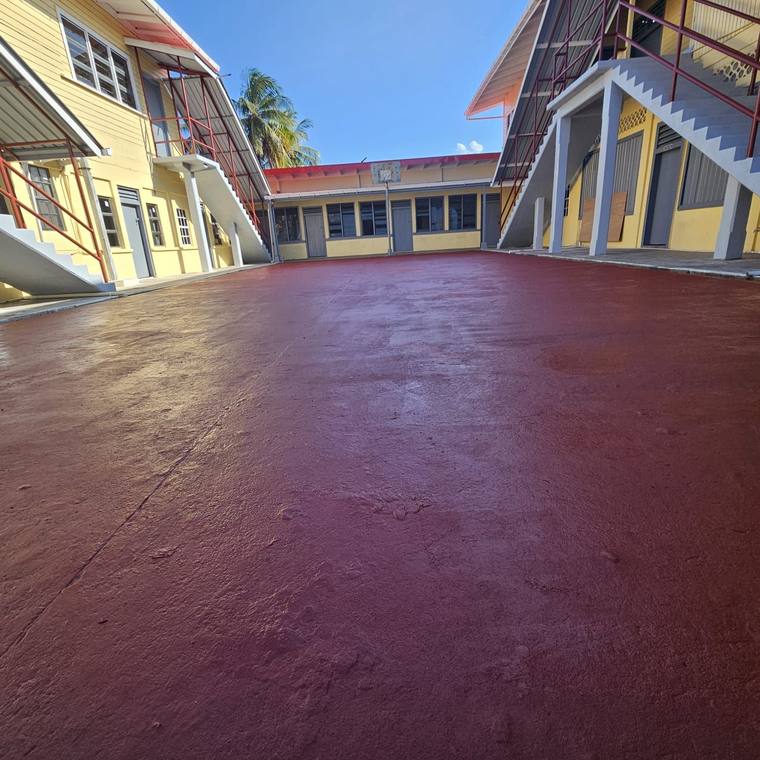 New coated concrete courtyard between two-storey buildings